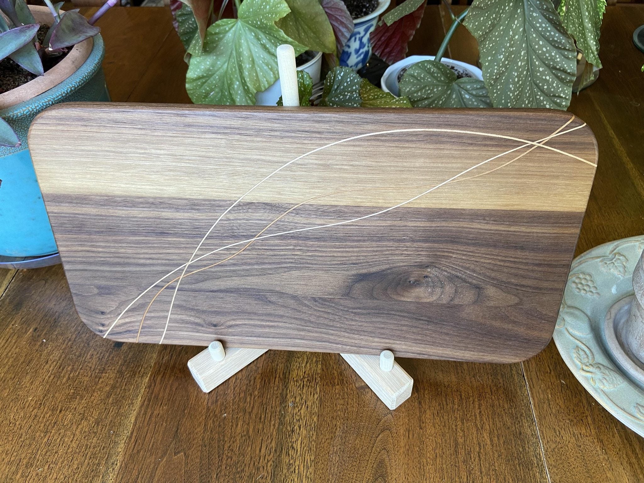 Walnut charcuterie board with cherry and maple decorative banding, handcrafted serving board