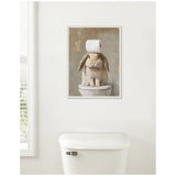 Painting of a brown and white bunny sitting on a toilet with a roll of toilet paper balanced on its head, set against a textured beige background.