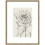 Black line drawing of a protea flower with leaves in a simple vase, framed with a light wood frame on a beige background.