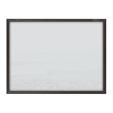 Framed minimalist print with soft gray and white tones suggesting a misty seascape or foggy landscape, bordered by a dark brown wooden frame with subtle metal accents.