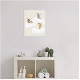 Framed canvas showing a fawn, rabbit, and fox sitting on fluffy white clouds with small yellow stars on beige background, hung above a white shelf with green decor.