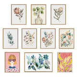 Set of 11 framed watercolor prints featuring botanical elements and two colorful artworks, including a girl with heart-shaped sunglasses and a pink banana-themed design.