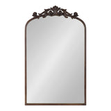 Rectangular arch-top mirror with a dark wood frame and ornate carved scrollwork decoration at the top center.