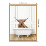 A shaggy Highland cow with long horns and brown fur sitting in a white vintage clawfoot bathtub filled with bubbles, against a white paneled wall and wooden floor.