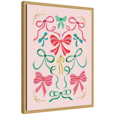 Sylvie framed canvas featuring decorative Christmas bows in shades of pink, green, and teal on a light pink background