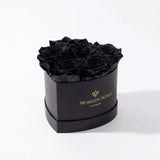 Baby Heart Black Box with six black roses arranged in a heart shape inside a sleek black box.