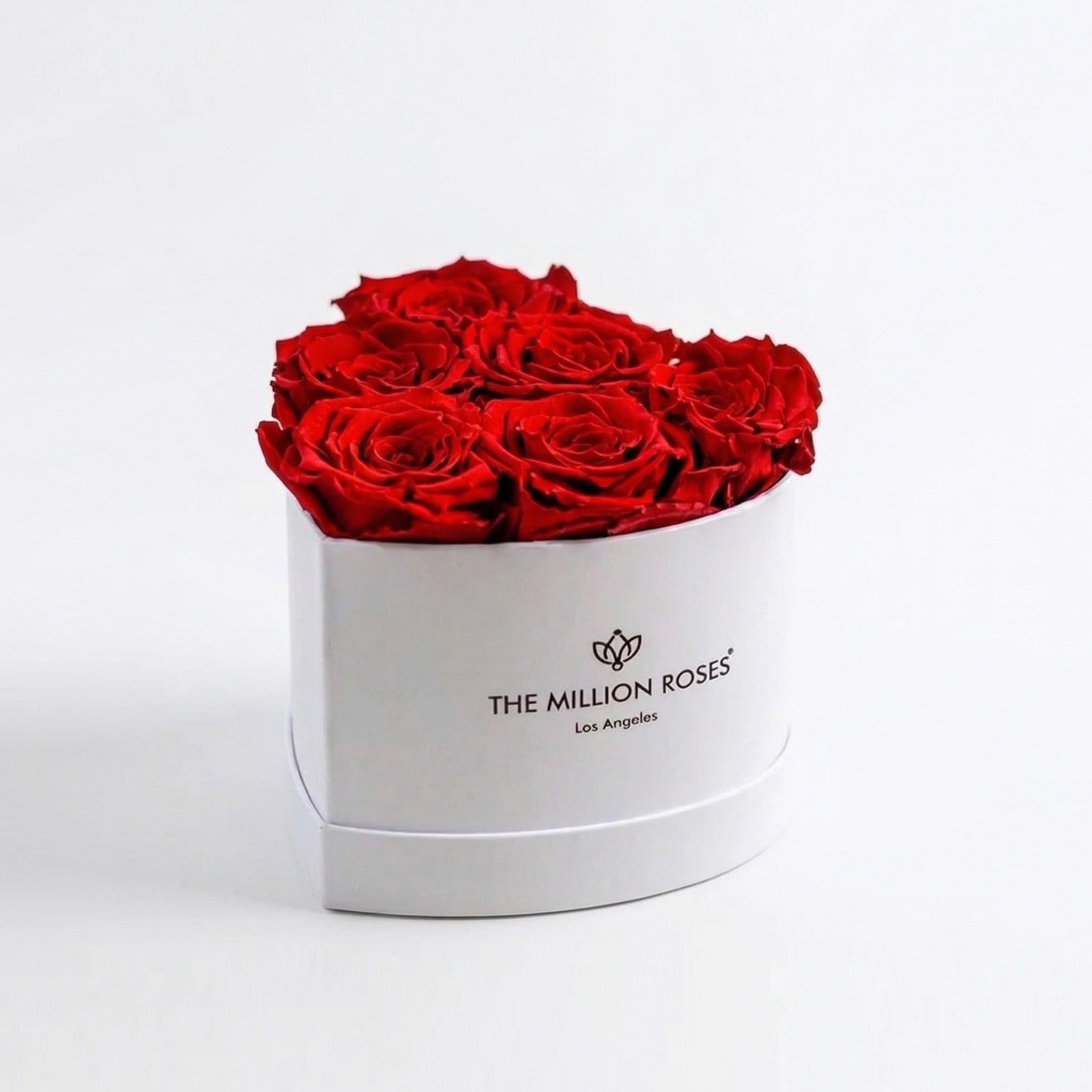 Six vivid red roses shaped into a heart in a white box from The Million Roses
