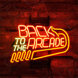 Neon sign with red and yellow lights spelling 'BACK TO THE ARCADE' mounted on a dark brick wall background.