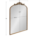 Arched mirror with a gold-toned frame and ornamental scrollwork at the top, measuring 36 inches tall and 24 inches wide with reflective glass surface.
