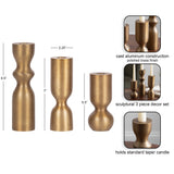 Three brass-finished cast aluminum candle holders in sculptural shapes, measuring 8.5, 7, and 5.5 inches tall, designed for standard taper candles.
