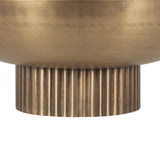 Close-up of a ribbed cylindrical base in brushed bronze metal supporting a smooth, rounded bowl with a soft metallic sheen.