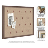 Rectangular pinboard with beige canvas featuring small red botanical prints, framed in dark brown wood, holding two black-and-white photos with pins.