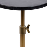 Close-up of a black marble tabletop with grey veining above a brass-colored adjustable metal support featuring a wingnut for height adjustment.