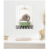Elephant sitting in a green clawfoot bathtub filled with bubbles on black and white checkerboard floor under a modern chandelier, framed on a white wall.