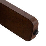 Close-up of a rounded rectangular dark wood table leg with a black adjustable leveling foot at the bottom corner.
