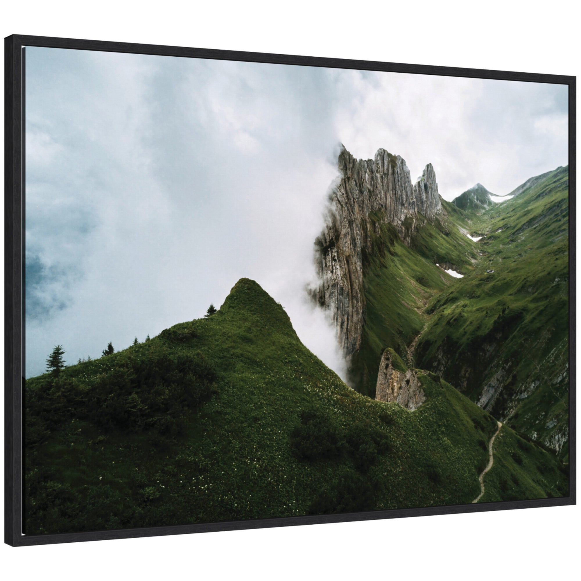 Framed canvas art showing mountain ridge and green meadow on a cloudy day.
