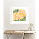 Watercolor painting of large orange and pink begonia flowers with green leaves, framed in white and hanging above a wooden desk with a white chair and ceramic vase.