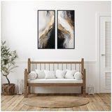 Two vertical abstract canvases with swirling black, white, gray, and gold tones, hung side by side above a wooden bench with white cushions in a minimalist room.