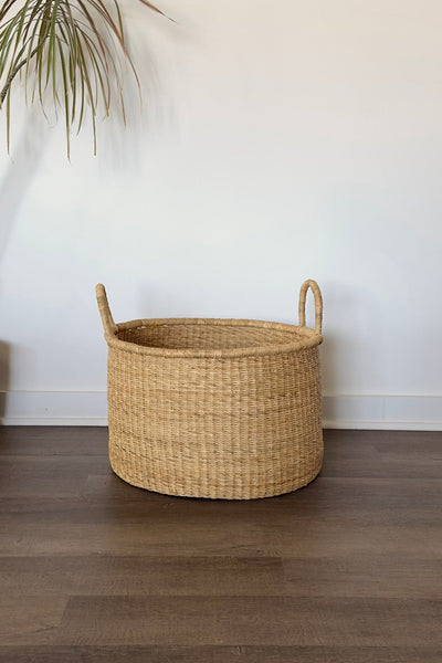 Natural colored handled hamper basket woven from elephant grass