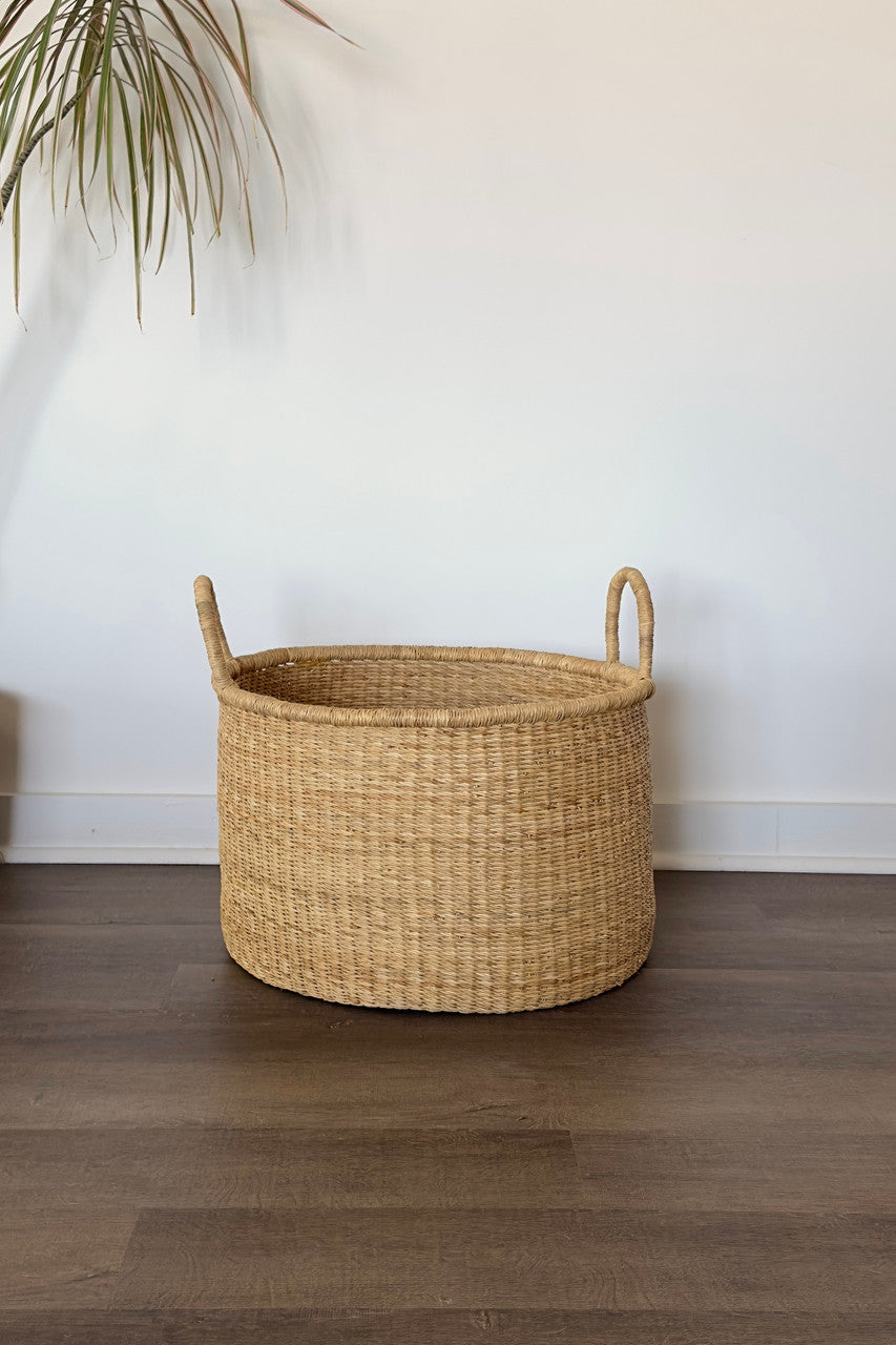Natural colored handled hamper basket woven from elephant grass