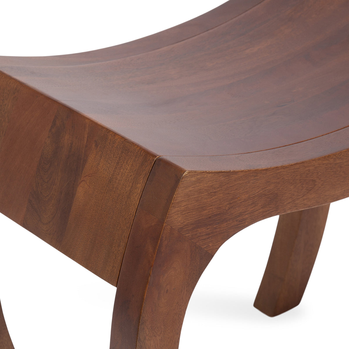Curved wooden stool seat with warm brown finish and rounded legs showcasing smooth grain and seamless joinery, photographed on a white background.