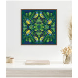 Framed canvas print featuring a symmetrical design of four yellow and blue birds perched among green leaves and flowers on a deep blue background.