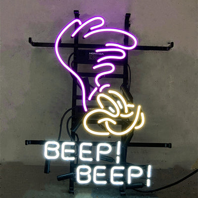 Brightly lit Plymouth Road Runner Superbird Beep Beep neon sign with red and blue glass tubes on metal grid backing.