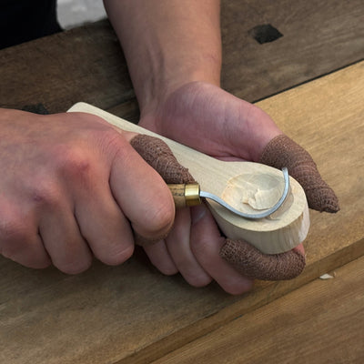 Beginner DIY Spoon Carving Kit with hand-forged knives, linden wood blanks, and carving tools laid out