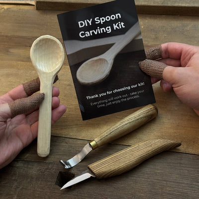 Beginner DIY Spoon Carving Kit with hand-forged knives, linden wood blanks, and carving tools laid out