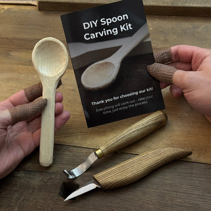 Beginner DIY Spoon Carving Kit with hand-forged knives, linden wood blanks, and carving tools laid out