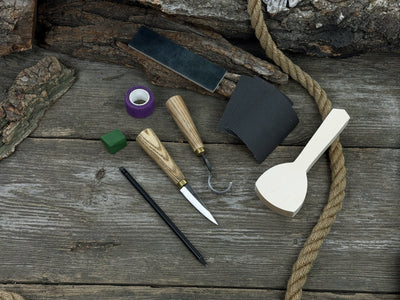 Beginner’s Spoon Carving Kit with sloyd knife, hook knife, wooden blank, sandpaper, sharpening board, pencil, and finger wrap
