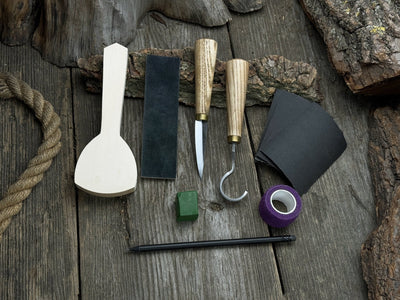 Beginner’s Spoon Carving Kit with sloyd knife, hook knife, wooden blank, sandpaper, sharpening board, pencil, and finger wrap