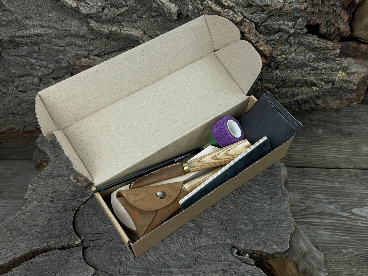 Beginner’s Spoon Carving Kit with sloyd knife, hook knife, wooden blank, sandpaper, sharpening board, pencil, and finger wrap