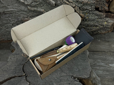 Beginner’s Spoon Carving Kit with sloyd knife, hook knife, wooden blank, sandpaper, sharpening board, pencil, and finger wrap