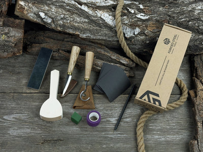 Beginner’s Spoon Carving Kit with sloyd knife, hook knife, wooden blank, sandpaper, sharpening board, pencil, and finger wrap