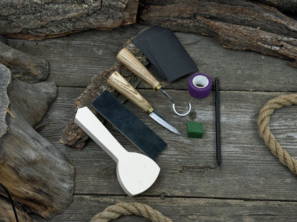 Beginner’s Spoon Carving Kit with sloyd knife, hook knife, wooden blank, sandpaper, sharpening board, pencil, and finger wrap
