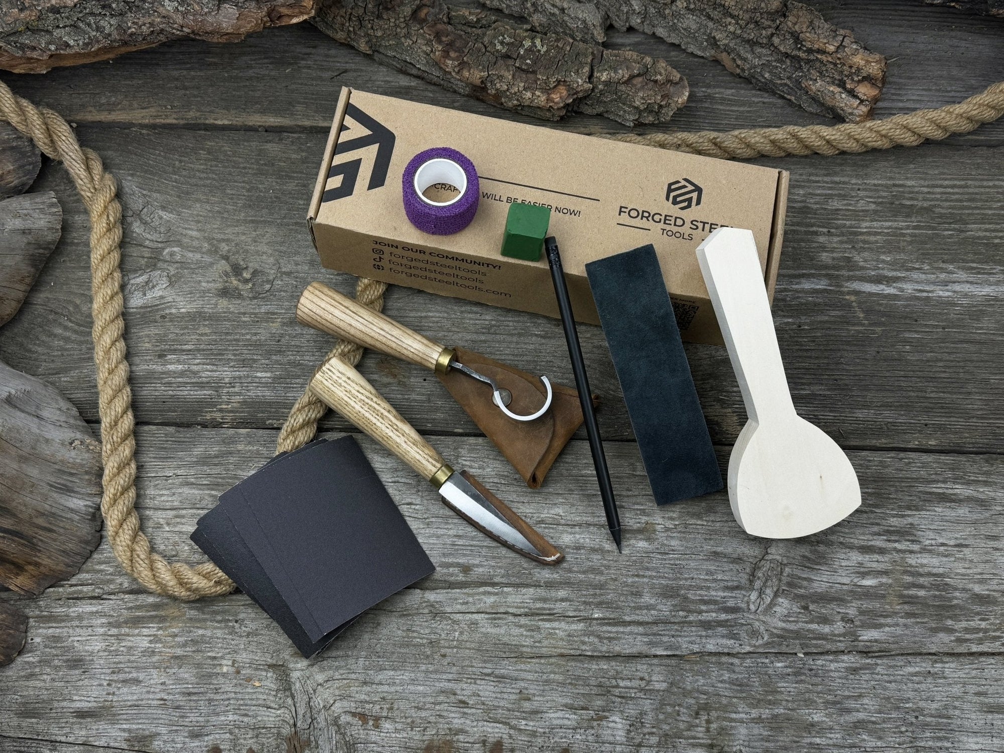 Beginner’s Spoon Carving Kit with sloyd knife, hook knife, wooden blank, sandpaper, sharpening board, pencil, and finger wrap