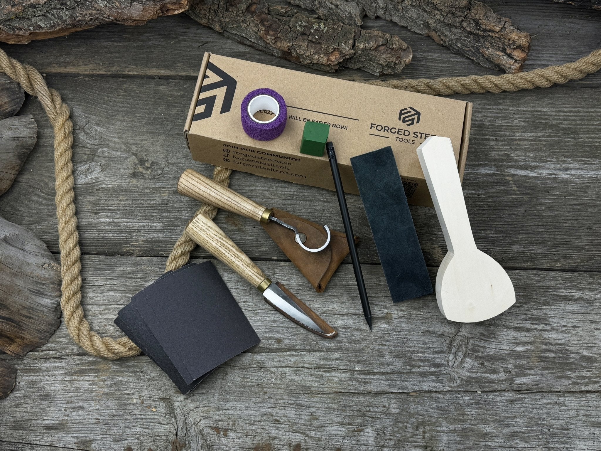 Beginner’s Spoon Carving Kit with sloyd knife, hook knife, wooden blank, sandpaper, sharpening board, pencil, and finger wrap