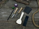 Beginner’s Spoon Carving Kit with sloyd knife, hook knife, wooden blank, sandpaper, sharpening board, pencil, and finger wrap
