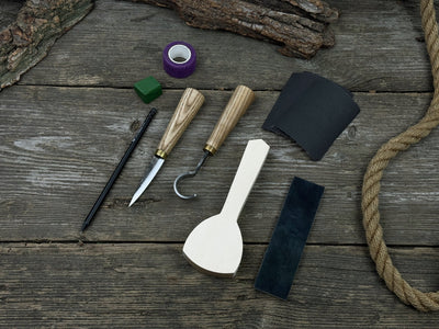 Beginner’s Spoon Carving Kit with sloyd knife, hook knife, wooden blank, sandpaper, sharpening board, pencil, and finger wrap