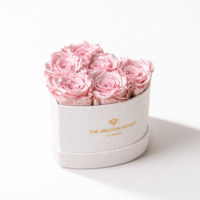 Beige box filled with 6 hand-formed light pink roses arranged into a heart shape