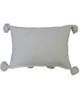 Cream rectangular accent pillow with large fluffy pom-poms and tassels at each corner, shown against a white background.