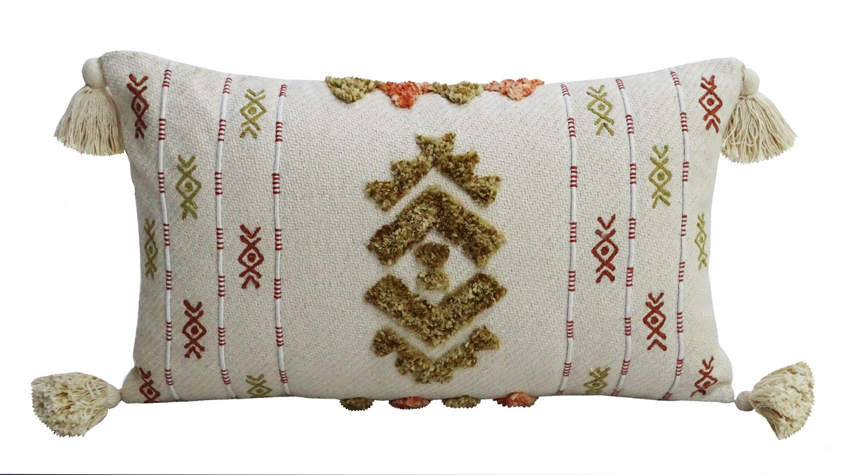 Rectangular cream throw pillow with tassels on all four corners and mustard yellow and rust red embroidered geometric patterns arranged vertically.