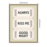 Framed wall art with sage green background featuring three pink-edged ticket shapes each displaying words: ALWAYS, KISS ME, GOOD NIGHT in bold black text.