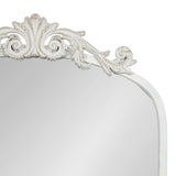 White traditional arch mirror with ornate carved scroll and floral details along the top edge, featuring distressed finish accents