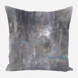 Square pillow with an abstract design in muted gray tones, featuring subtle touches of blue and soft beige brushstrokes.
