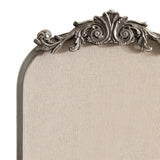 Top portion of an arched pinboard with a neutral linen fabric surface and an ornate silver-toned decorative frame featuring scroll and leaf motifs.