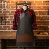 Black leather work apron with adjustable straps and large front pockets