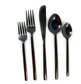 Black flatware set with knives, forks, and spoons laid out on a woven placemat