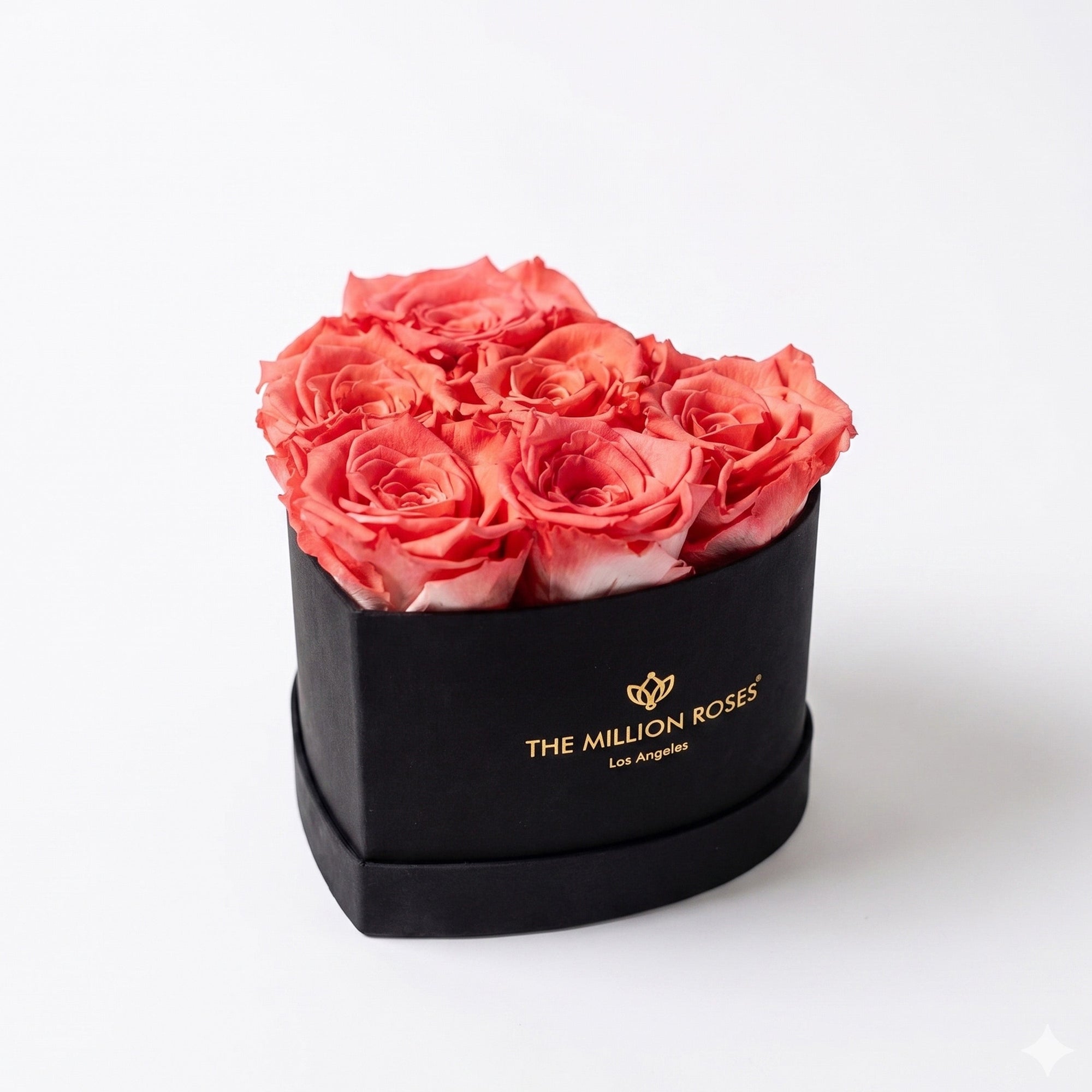 Baby Heart Black Box with coral colored roses arranged in a heart shape inside a black square box